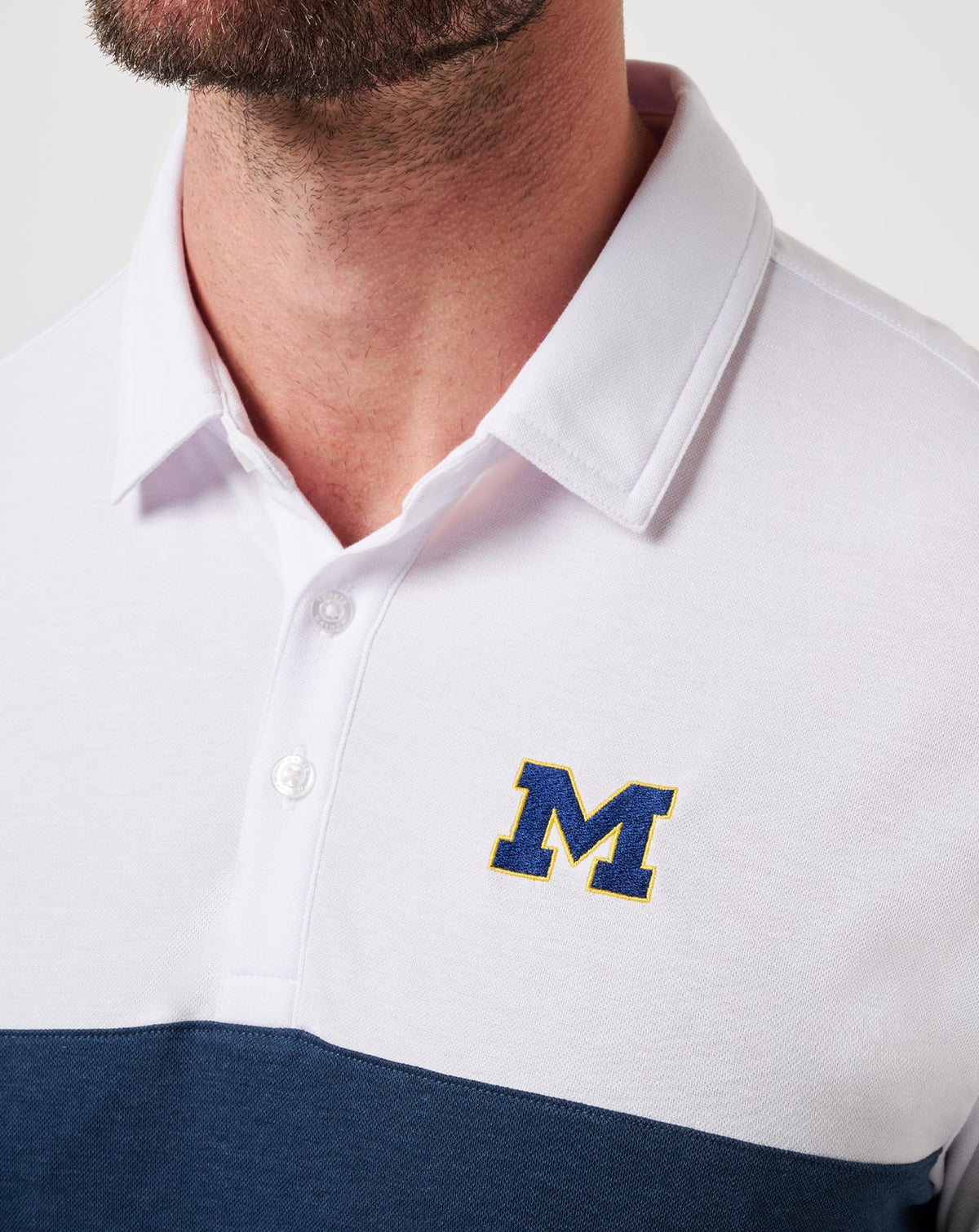 Michigan Drop Back Polo White/Navy | Travis Mathew