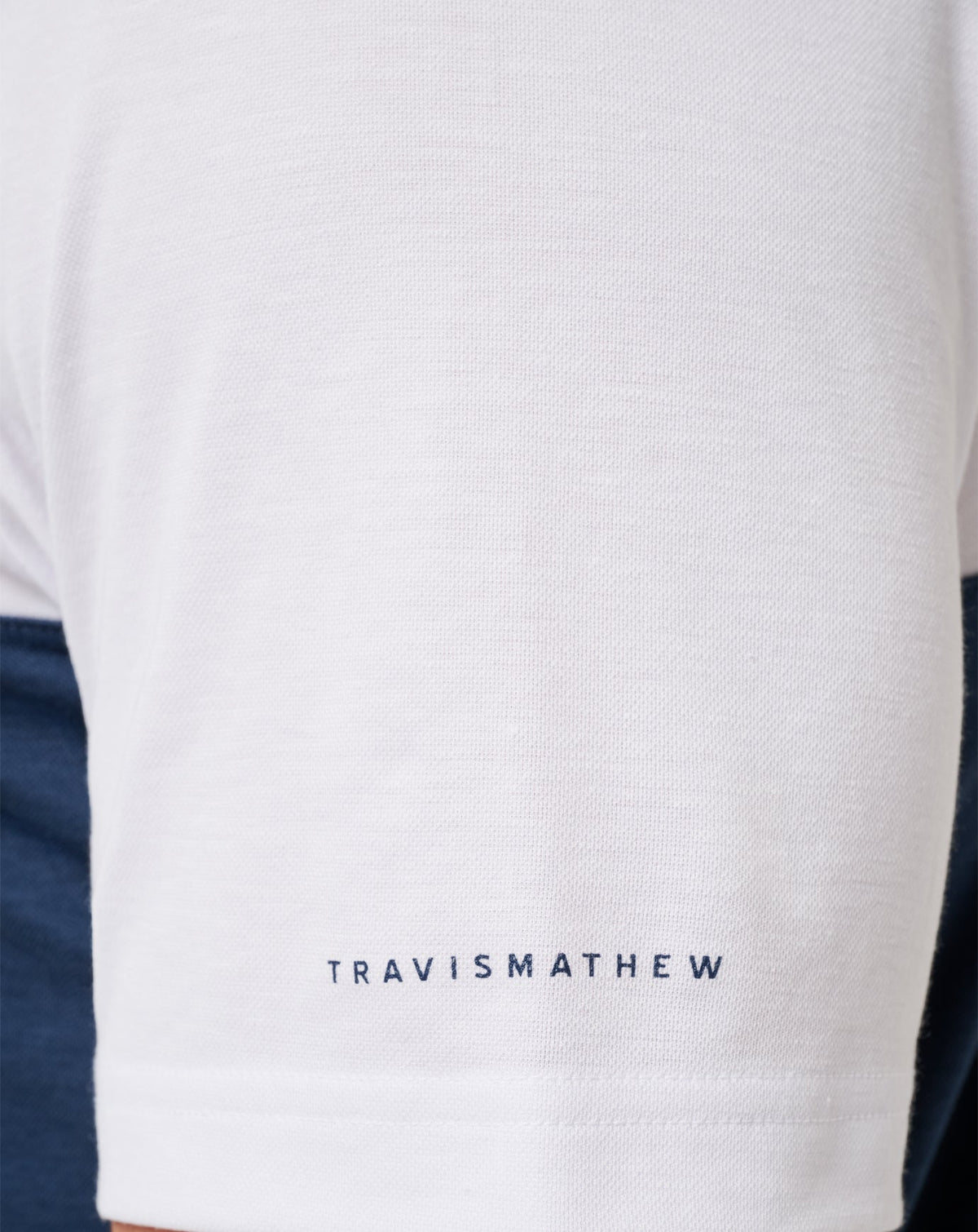 Michigan Drop Back Polo White/Navy | Travis Mathew